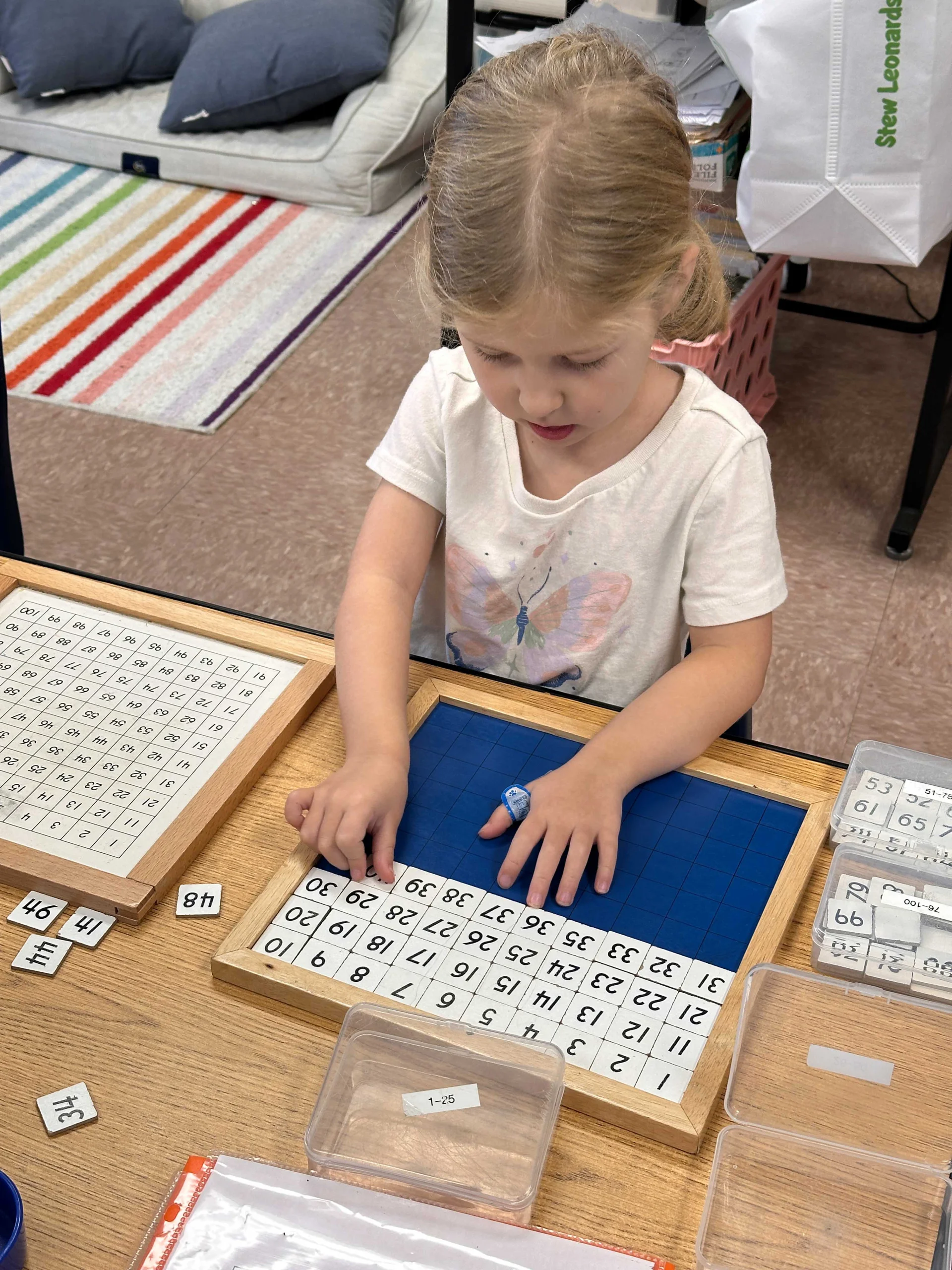 Toddler at her daycare in danbury with math tiles