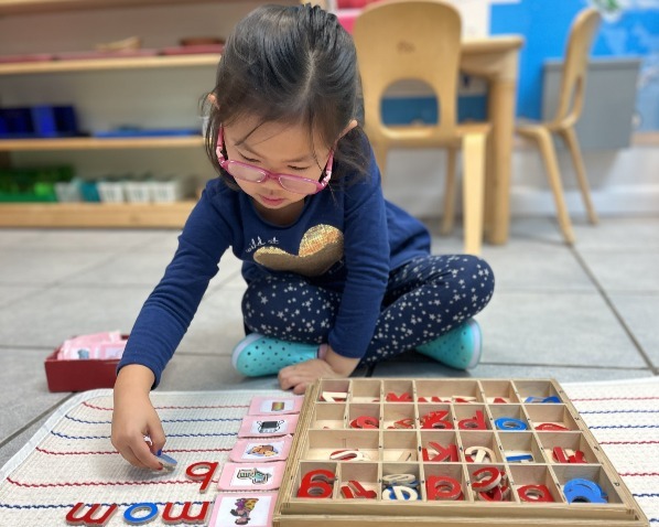 child working with movable alphabet